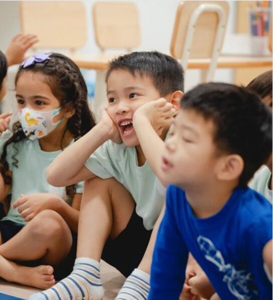 Children smiling and laughing during a lesson at Lighthouse Preschool