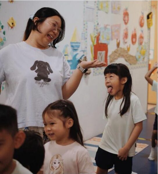 Teacher and children making silly faces together at Lighthouse Preschool