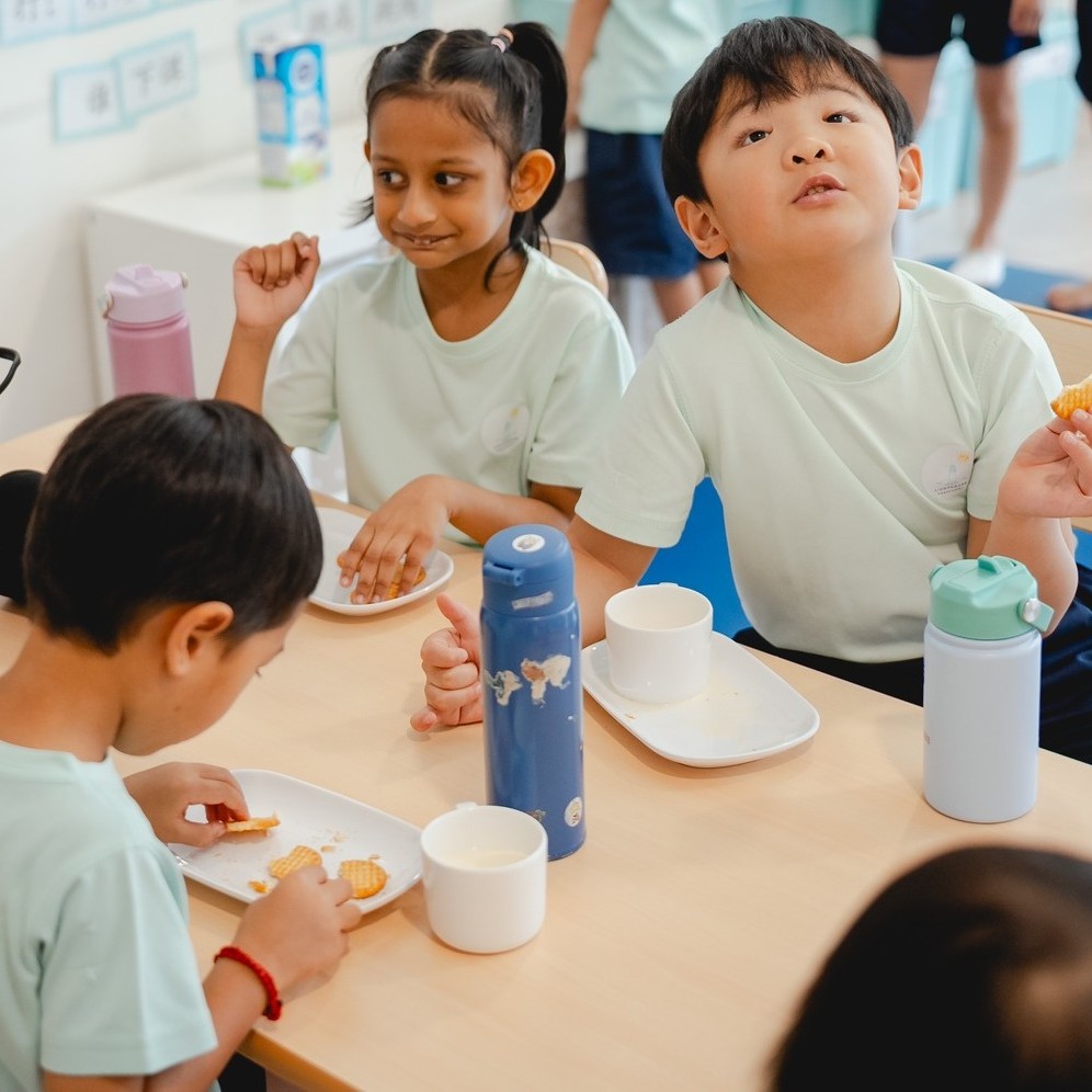 Children washing snack plates together at Lighthouse Preschool